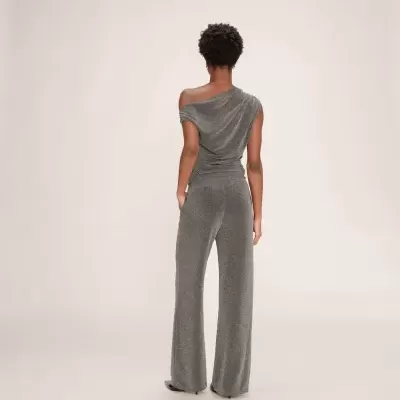 Macacão cinza brilhante de uma peça com calças largas visto de costas