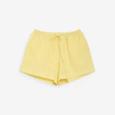 Calções amarelos com padrão de quadrículas e cordão na cintura.