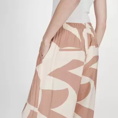 Calças largas padrão terra creme cintura elástica com bolsos laterais e traseiro