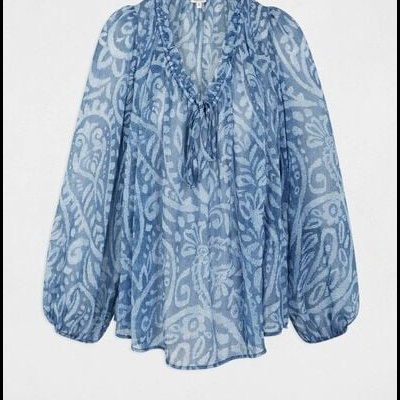 Blusa azul translúcida com padrão floral branco e mangas bufantes