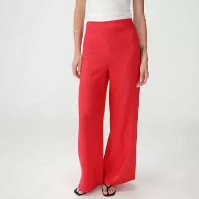Pantalonas vermelhas de corte largo com top branco e sandálias pretas