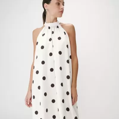 Vestido branco com bolinhas pretas, gola alta e sem mangas