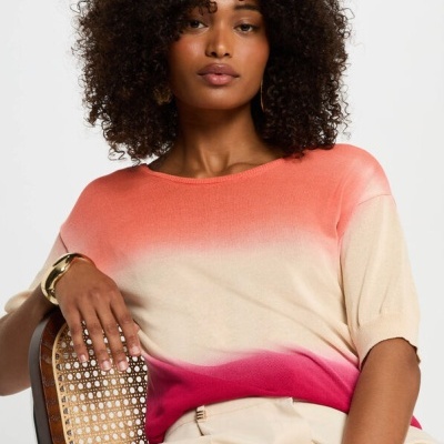 Camisola degradé coral a rosa com mangas curtas num ambiente minimalista