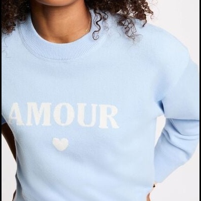 Camisola azul clara com a palavra AMOUR em branco no peito