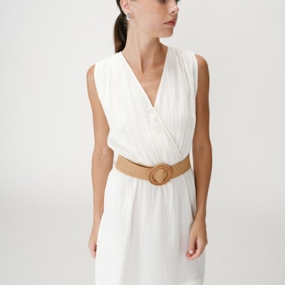 Vestido branco com cinto castanho em mulher jovem