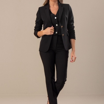 Mulher a vestir blazer e calças pretas com sapatos de padrão animal print