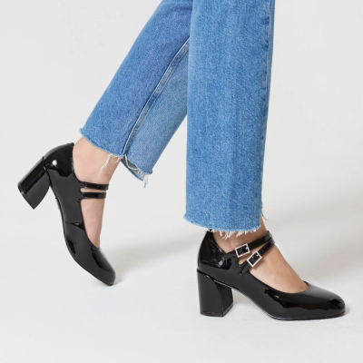 Sapatos de salto alto preto verniz com fivelas, calças de ganga azul