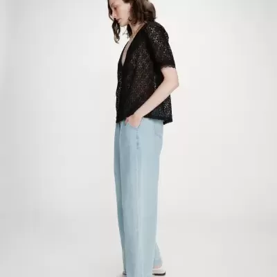 Top de renda preto transparente com calças largas de ganga azul clara