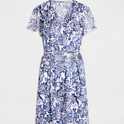 Vestido branco com padrão floral azul e cinto tecido à cintura