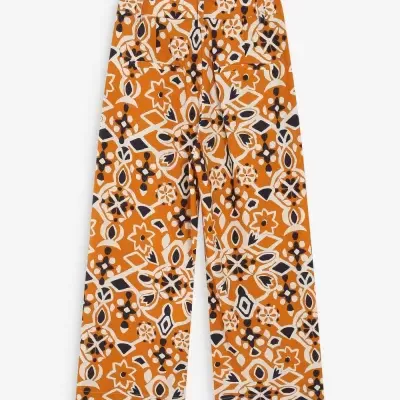 Calças largas com padrão floral em laranja, branco e preto