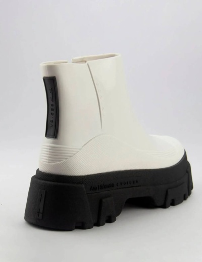 Bota branca com sola preta grossa vista de trás