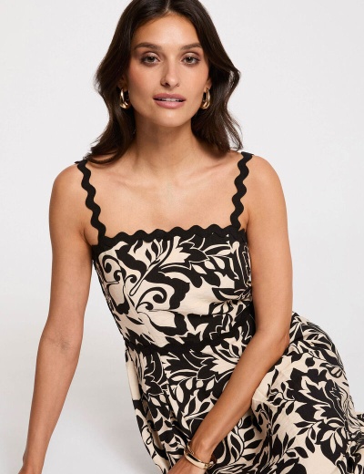 Vestido feminino com padrão floral preto e bege e alças onduladas