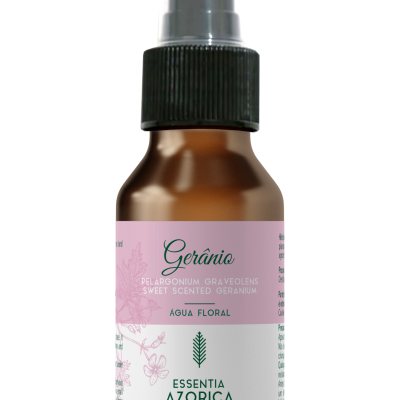 Frasco castanho com spray preto e etiqueta rosa e branca de água floral de gerânio