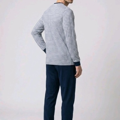 Homem de pijama cinzento com riscas e calças azul escuro