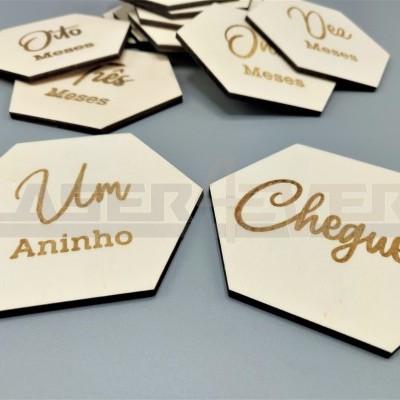 Placas hexagonais de madeira com gravação dourada em português