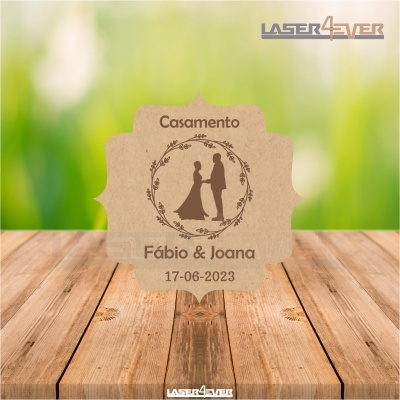 Convite de casamento em papel kraft com silhueta de casal e texto personalizado, sobre mesa de madeira