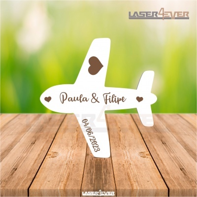 Figura decorativa avião branco com corações e texto Paula & Filipe 04 06 2023 sobre madeira