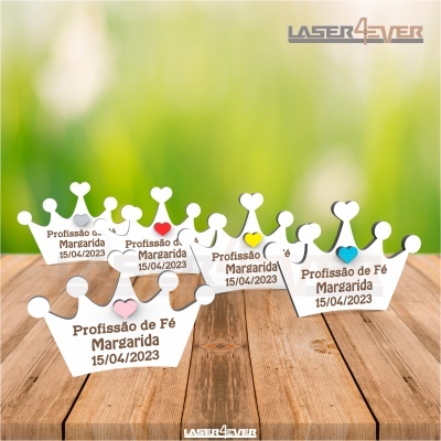 Coroas de papel branco com texto comemorativo sobre mesa de madeira