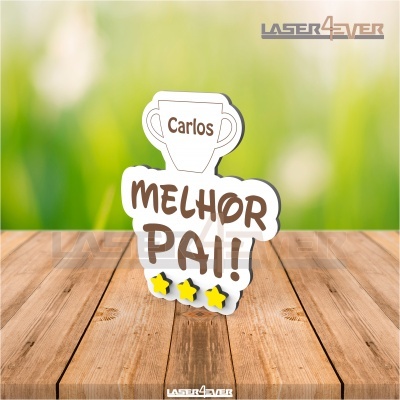 Objeto decorativo em madeira com texto 'Carlos MELHOR PAI!' e estrelas amarelas
