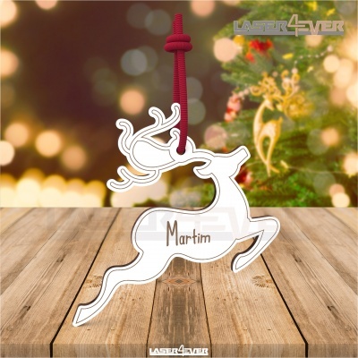 Decoração de rena branca com cordão vermelho e nome Martim, sobre mesa de madeira, fundo iluminado natalício