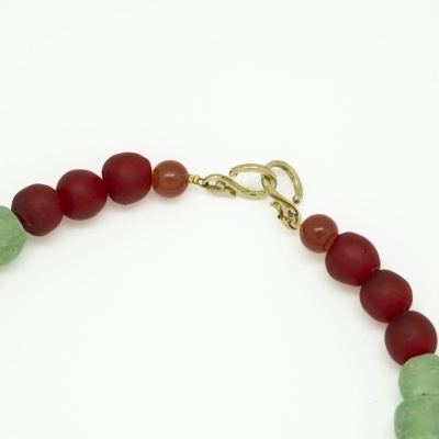 Colar com contas vermelhas e verdes e fecho dourado