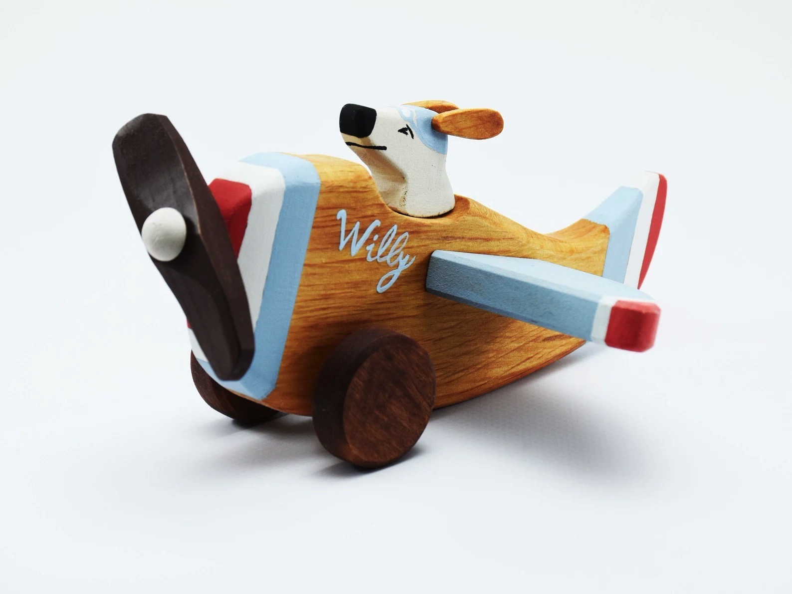 avião de brinquedo de madeira azul e castanho com figura de cão e texto 'Willy'