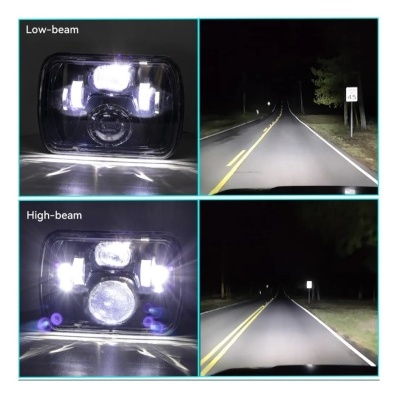 Farol de veículo com luz baixa e alta iluminando estrada à noite