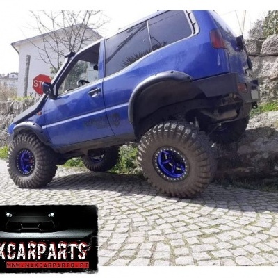 Veículo todo-o-terreno azul com pneus grandes em rua de calçada e logotipo MAXCARPARTS