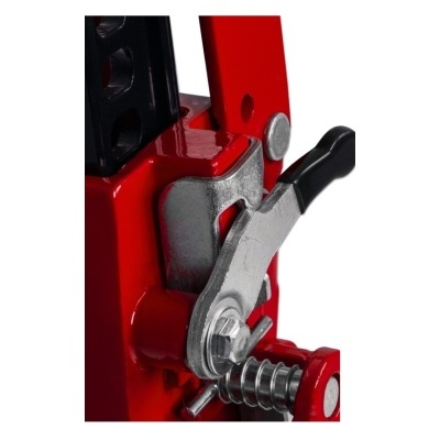 Detalhe de equipamento metálico vermelho com alavanca e mola