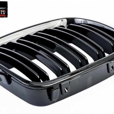 grelha frontal preta com barras verticais e moldura para automóvel