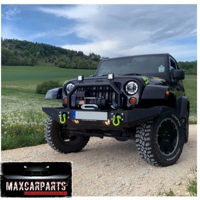 Jeep todo-o-terreno preto com acessórios e pneus off-road num ambiente rústico