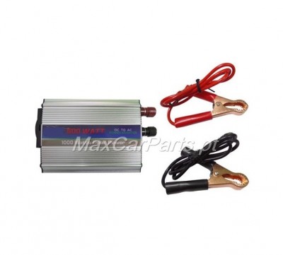 Inversor de corrente metálico com cabos de garras vermelha e preta sobre fundo branco.