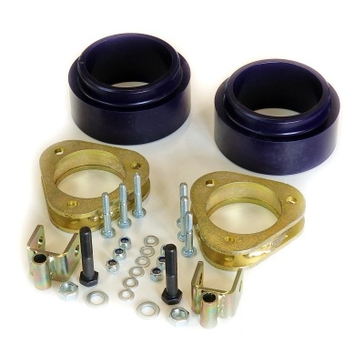 Conjunto de elevação para suspensão automóvel com borracha preta e suportes metálicos dourados.