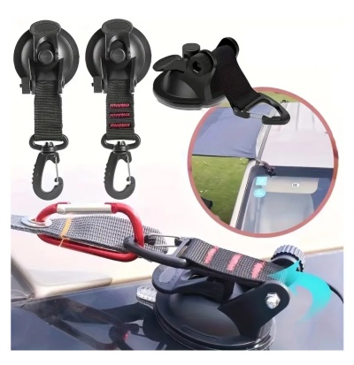 Duas ventosas negras com ganchos e correias pretas e vermelhas, fixadas num barco.