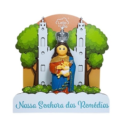 Figura Nossa Senhora dos Remédios com coroa, túnica colorida e criança, fundo com igreja e árvores, texto na base