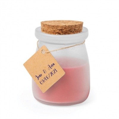 Vela rosa em frasco de vidro com tampa de cortiça e etiqueta com texto