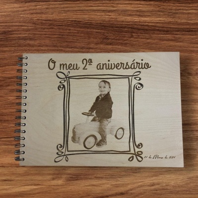 Livro de madeira com capa gravada de criança e texto 