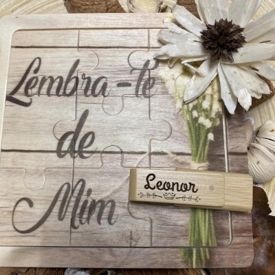 Puzzle de madeira com texto e pen drive de madeira com nome ao lado, decoração floral e elementos naturais ao redor