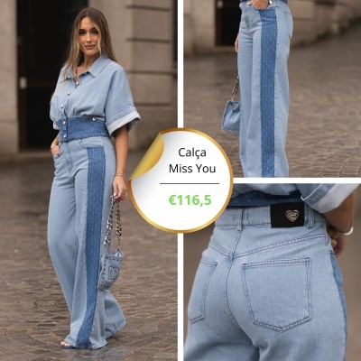 Mulher vestindo conjunto de ganga azul clara e escura com padrões pontilhados em ambiente urbano pavimentado