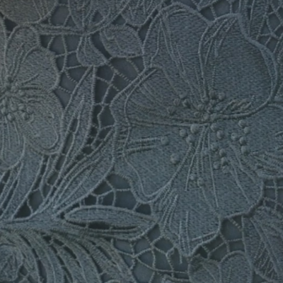 Tecido azul com bordado floral detalhado