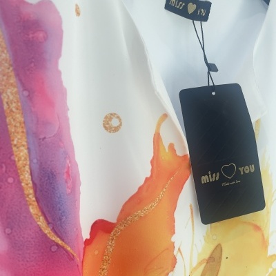 Blusa ou vestido com padrão colorido abstrato e etiqueta 'miss ♥ you'