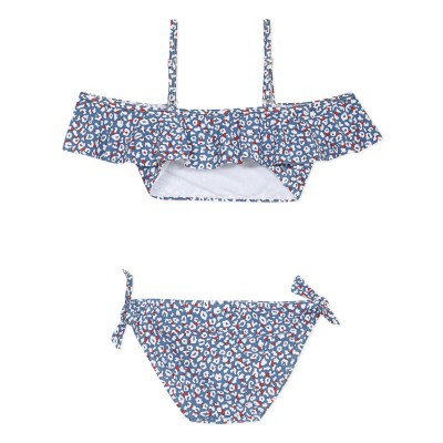 Conjunto de bikini infantil azul com padrão de pintas e detalhes de volante e laços