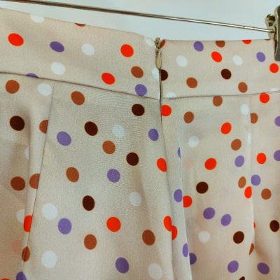 Saia bege com bolinhas coloridas, fecho e argola dourada na cintura