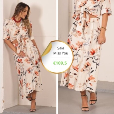 Saia comprida com padrão floral laranja e preto sobre fundo branco