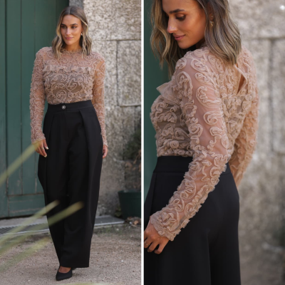 Mulher com blusa bege transparente decorada e calças pretas elegantes