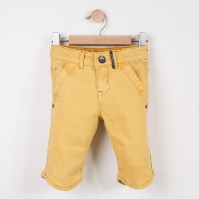 Calções de criança amarelos em cabide de madeira