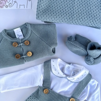 Conjunto de roupa de bebé verde-água e branco com casaco, jardineira, body, botinhas e manta.