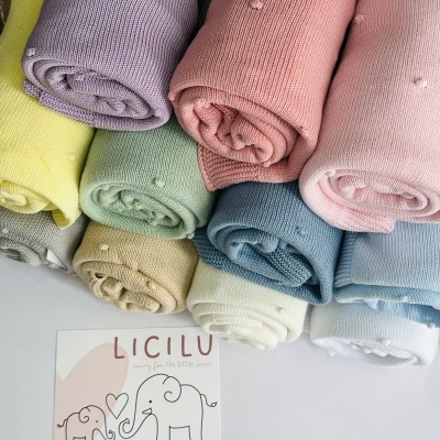 Mantais ou tecidos coloridos enrolados com cartão LICILU com desenho de elefantes