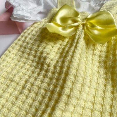 Vestido de bebé amarelo com laço de cetim e parte superior branca com renda