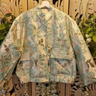 Casaco bordado floral verde azul bege com botões e bolsos pendurado em cabide